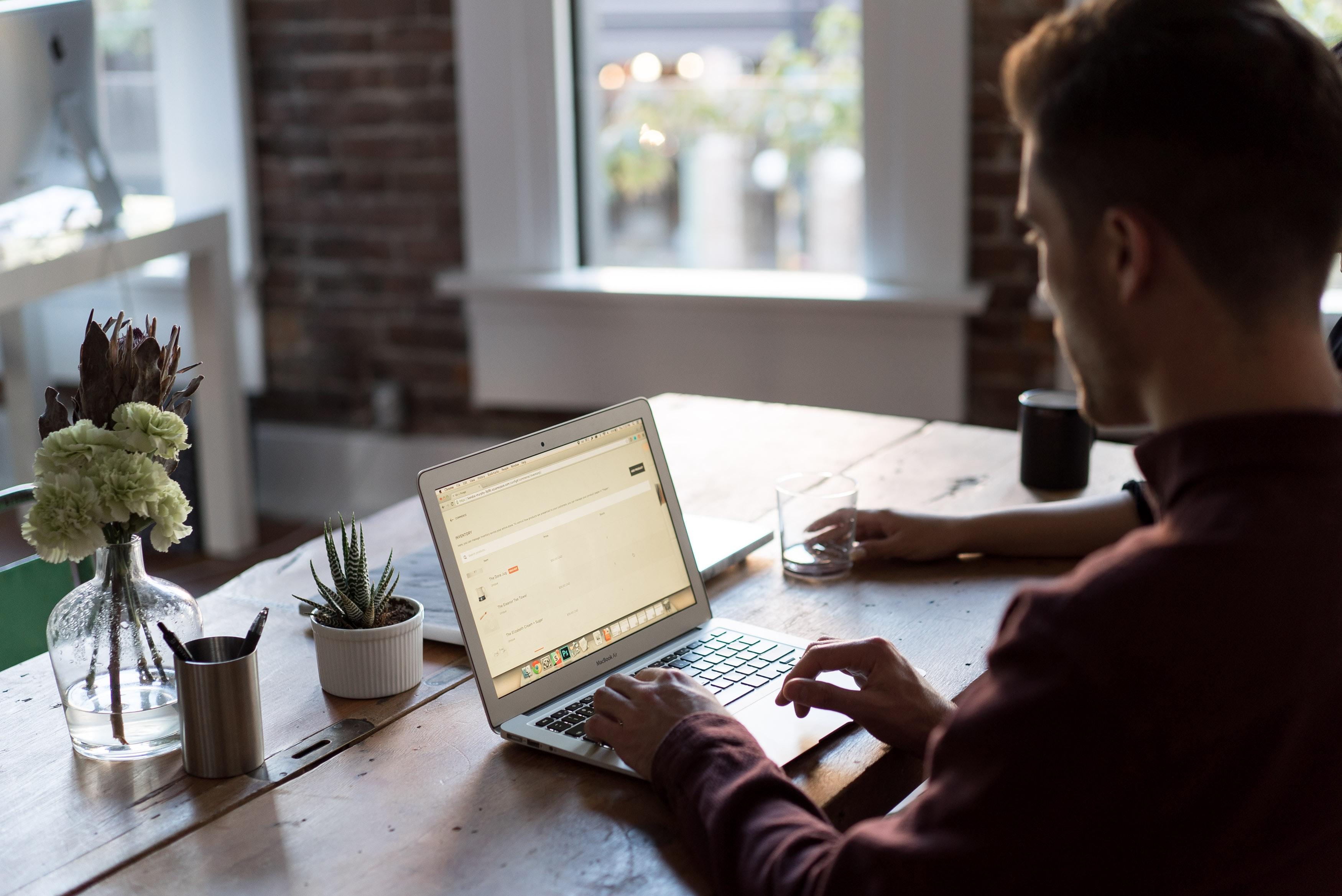 Man sitting at a computer typing